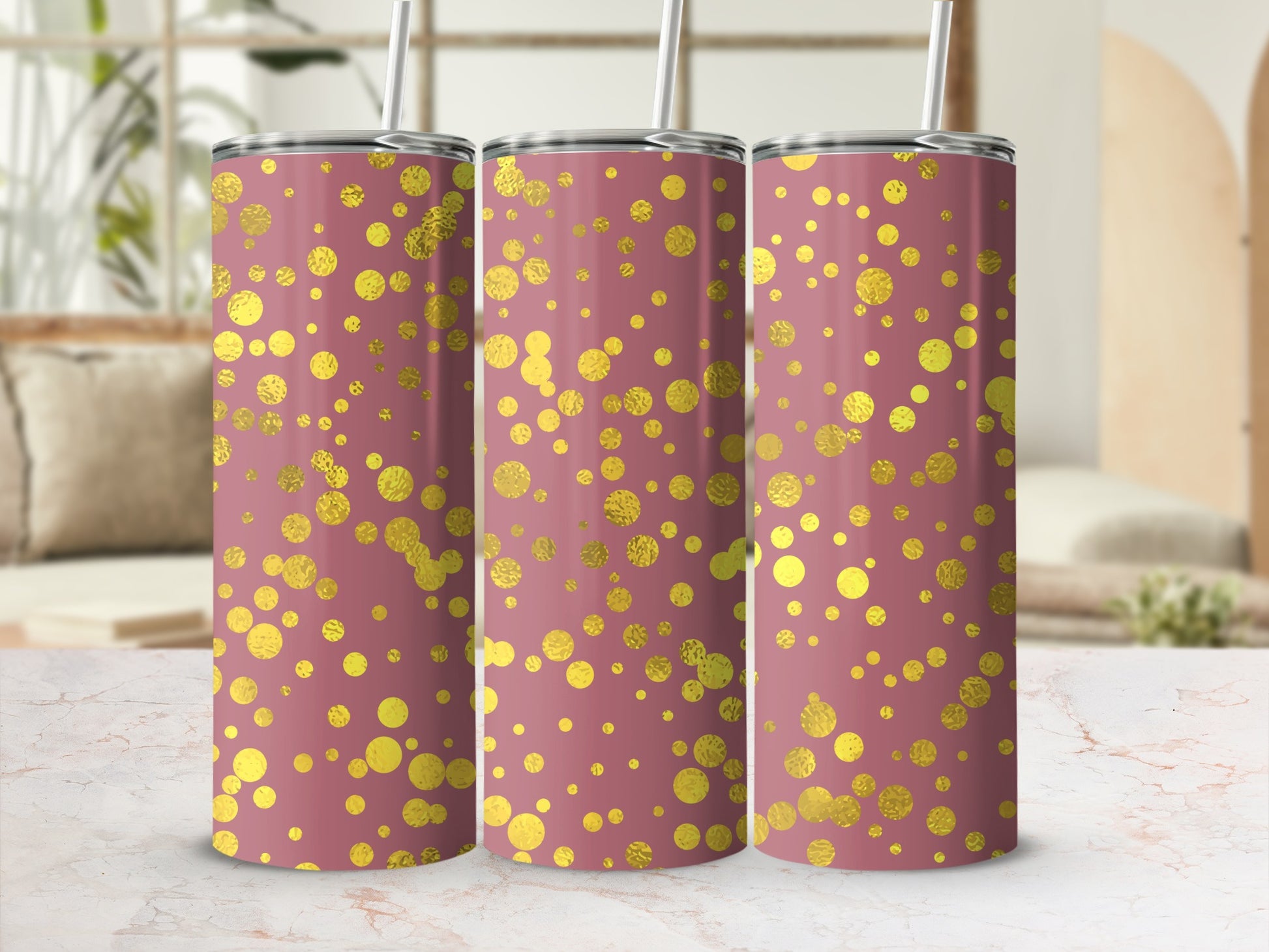 Three rose gold tumblers with gold confetti pattern and straws.