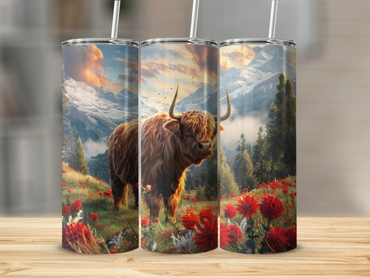 Highland cow in mountain meadow with red flowers.