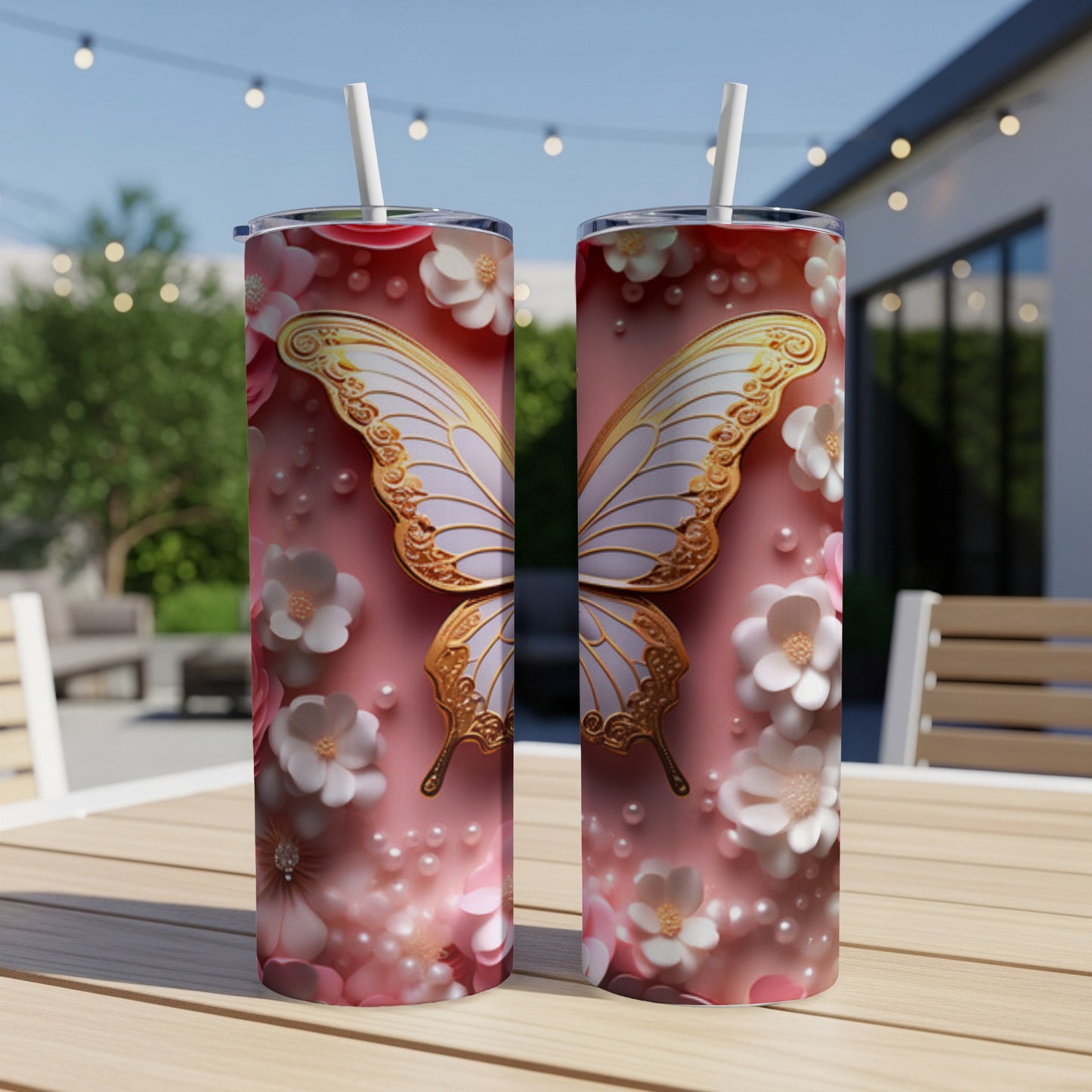 Two tumblers with butterfly and floral designs on a table.