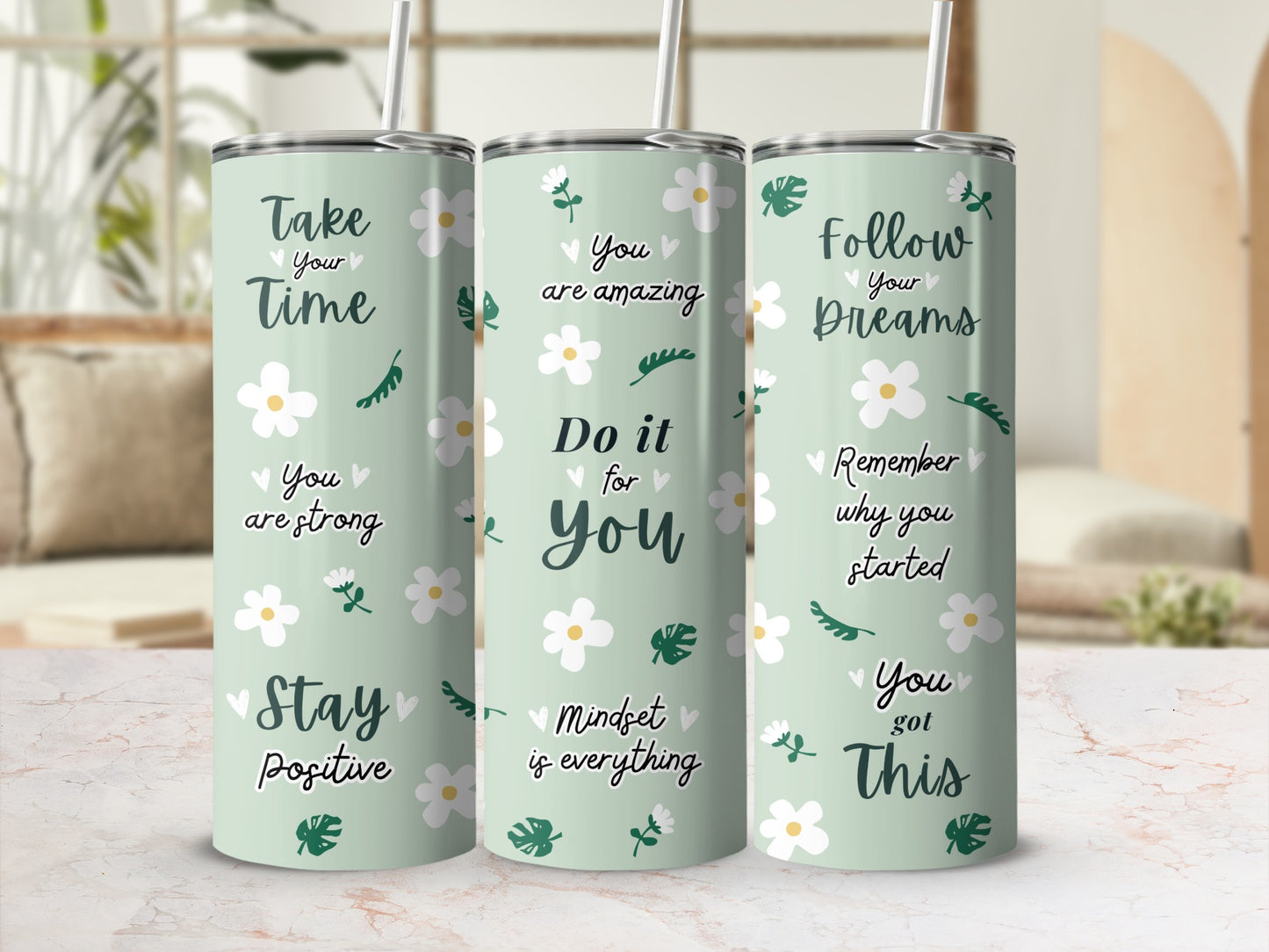 Three tumblers with inspirational quotes and floral designs.
