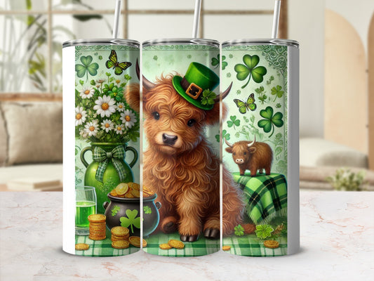 Highland cow with St. Patrick's Day hat and shamrocks on tumbler.