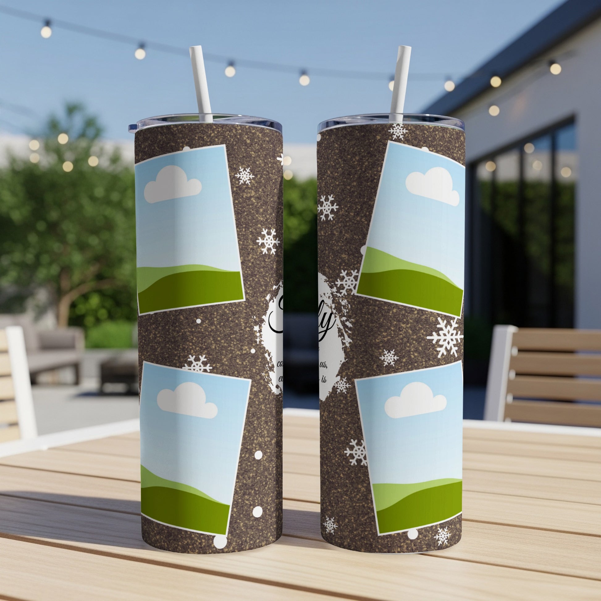 Two tumblers with a brown speckled pattern, snowflakes, and photo frames with clouds and green hills.