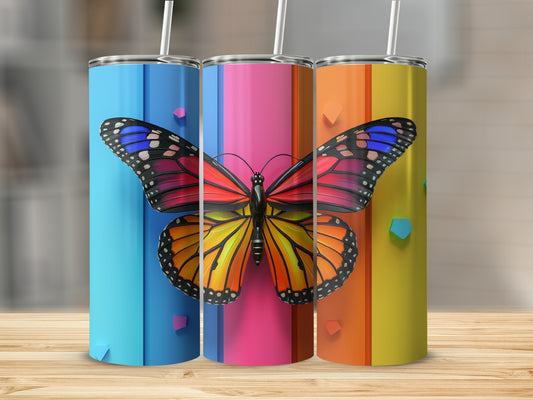 Three tumblers with colorful butterfly designs on a wooden surface.