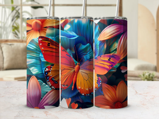 Three tumblers with colorful floral and butterfly designs, displayed on a counter.