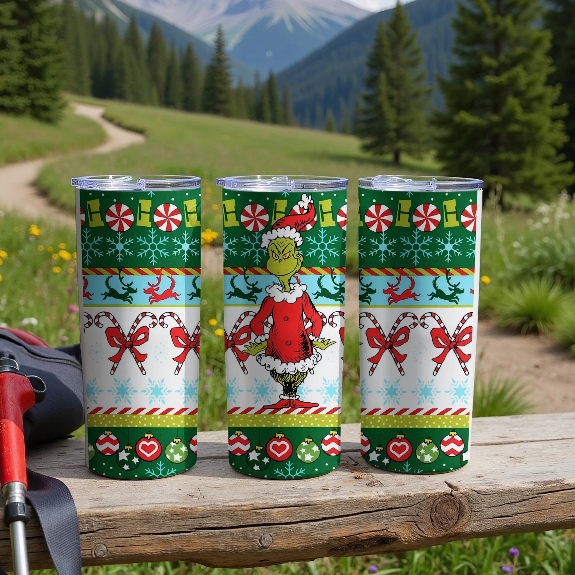 The Grinch Christmas tumbler with candy canes and snowflakes pattern.