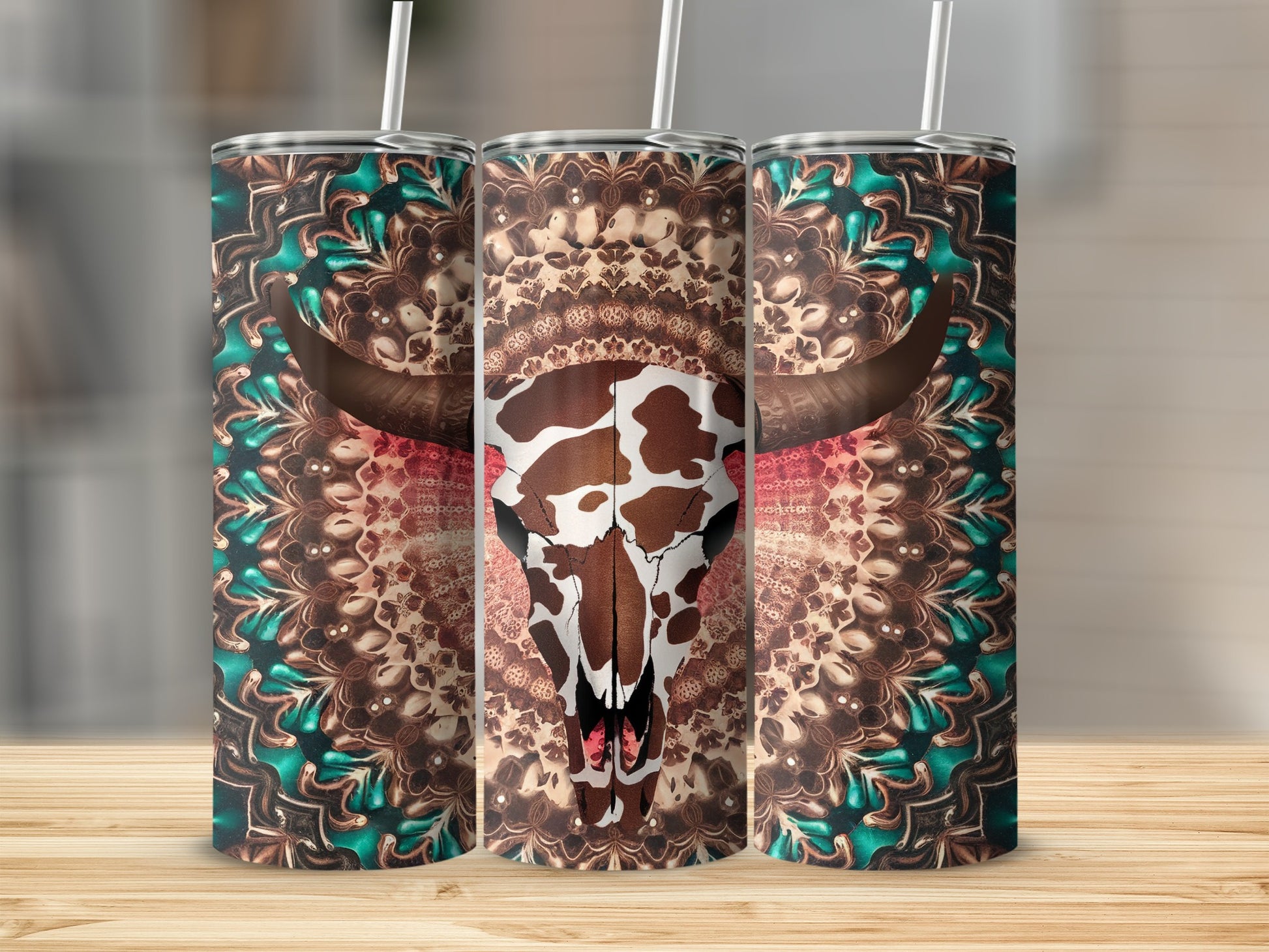 Cow skull with ornate mandala pattern on three tumblers.