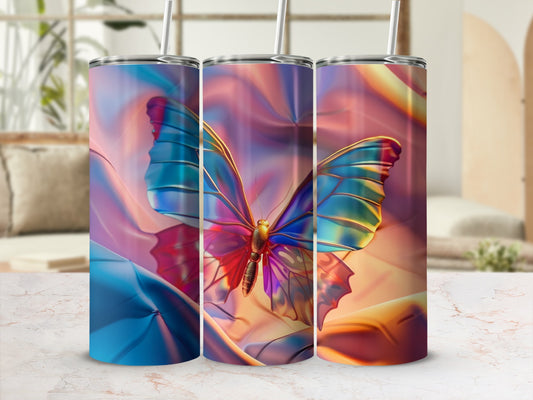 Iridescent butterfly design on three tumblers with straw, set against a blurred background.