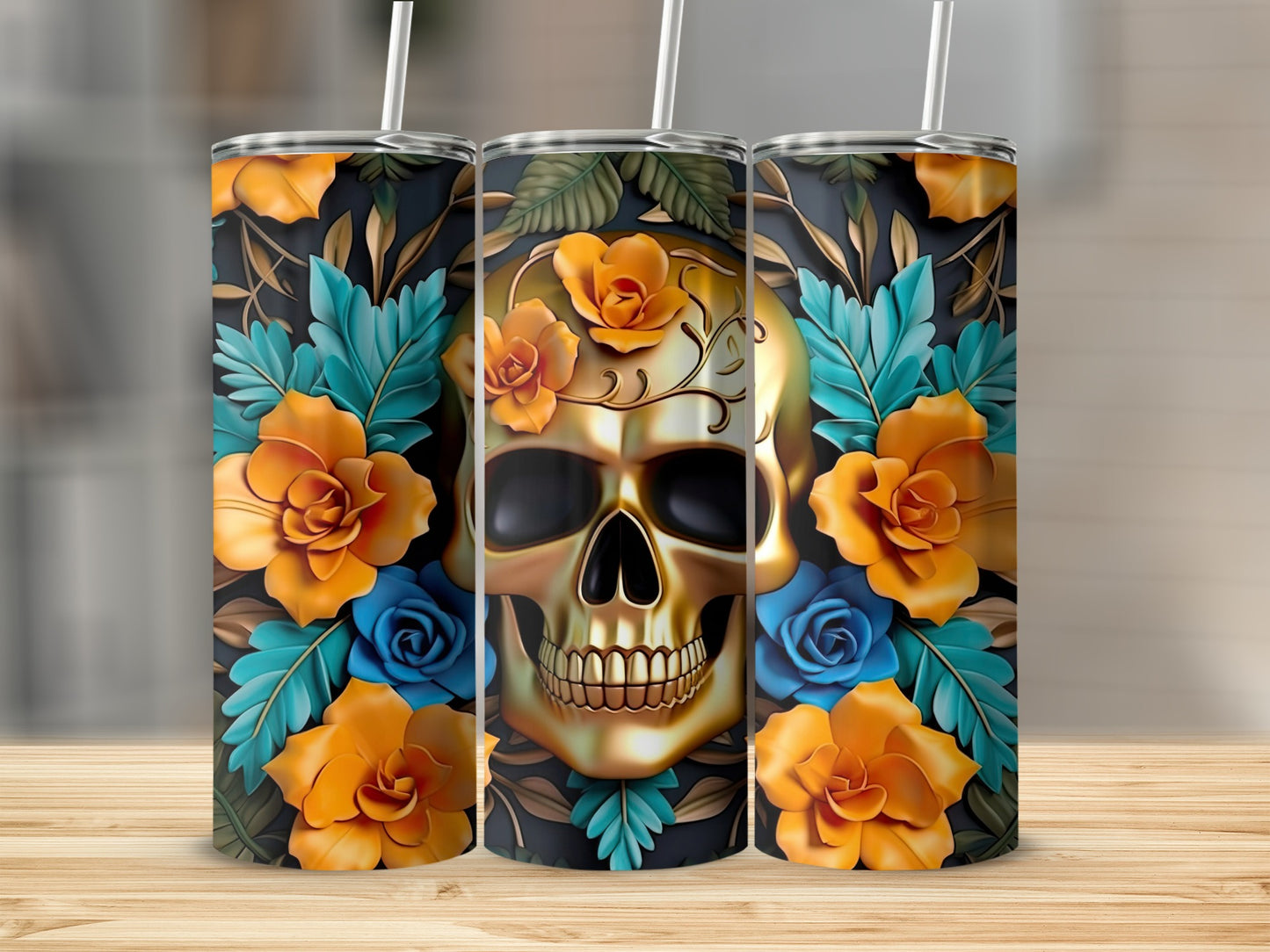 Three tumblers with a golden skull and floral design on a wooden surface.