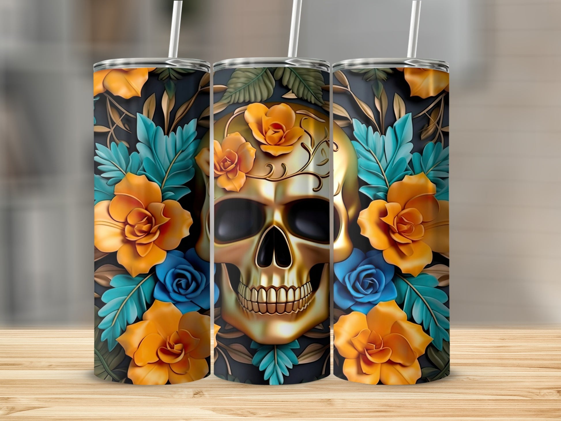 Three tumblers with a golden skull and floral design on a wooden surface.