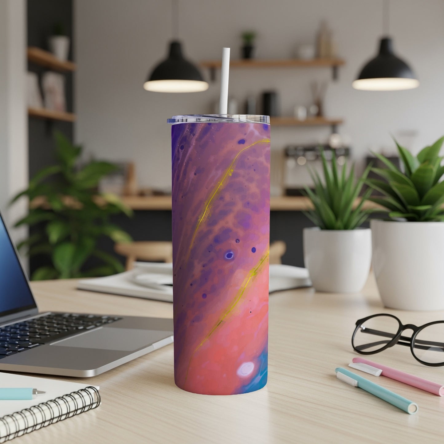 Tumbler with abstract purple, pink, blue, and gold design, with straw.