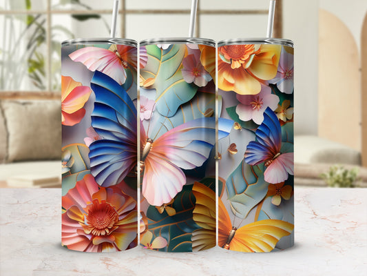 Three tumblers with floral and butterfly designs displayed on a table.