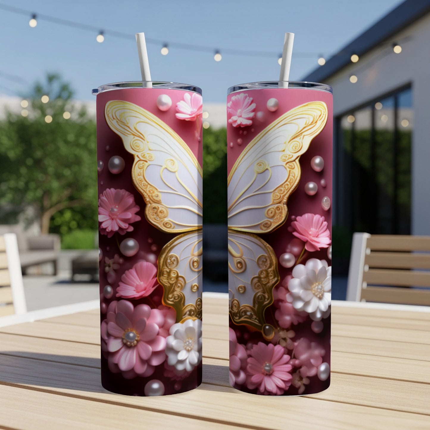 Two pink tumblers with white butterfly and floral designs sit on a table.
