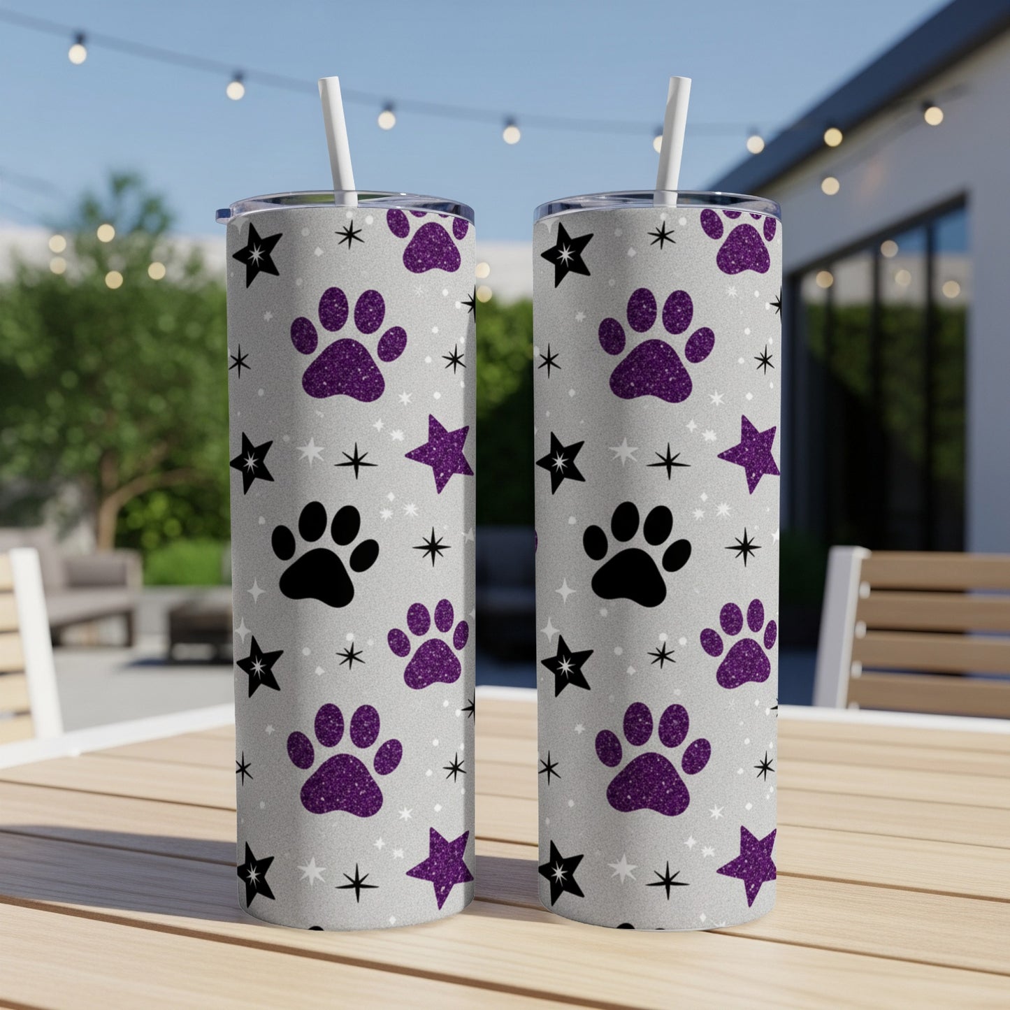 Two glittery tumblers with paw print and star pattern.