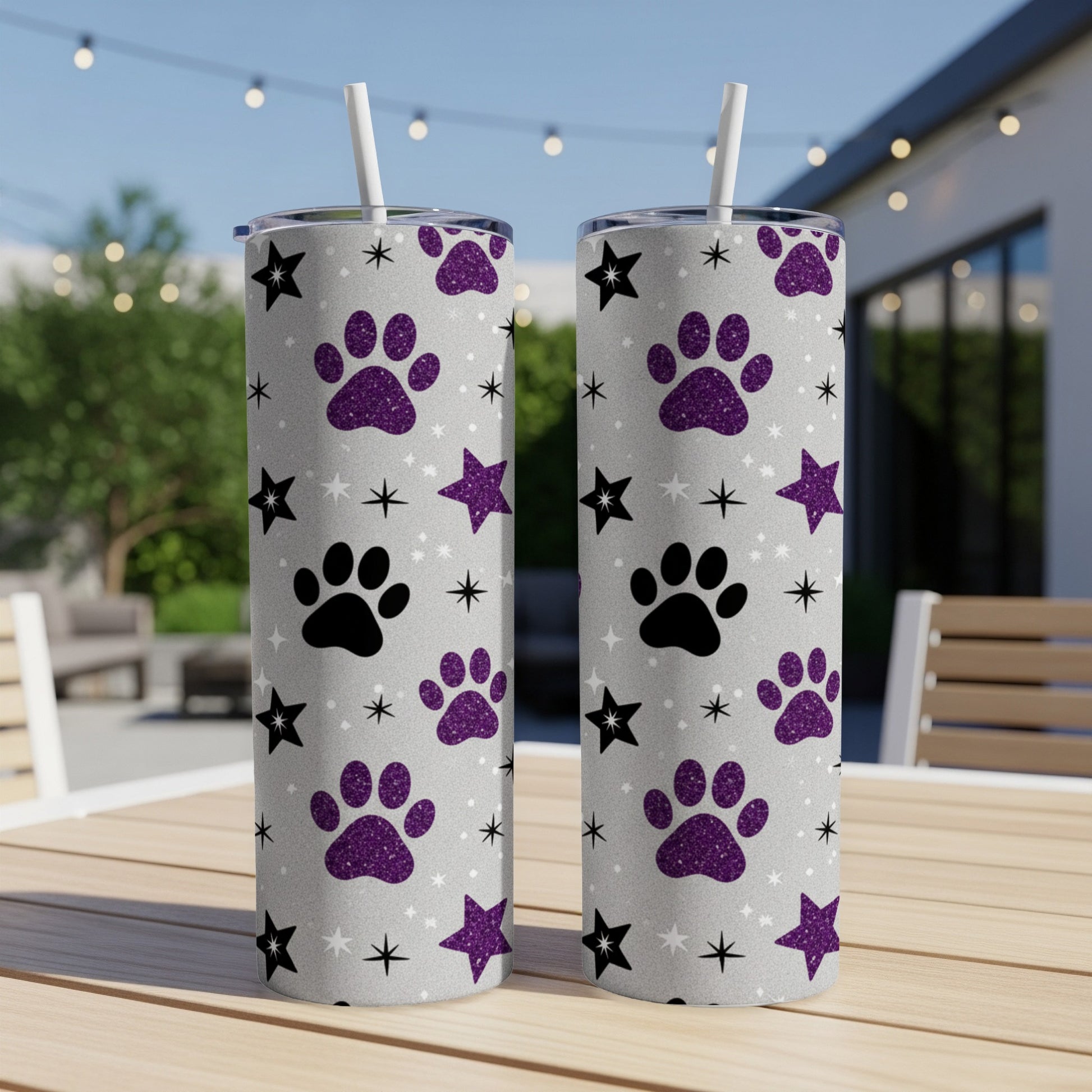 Two glittery tumblers with paw print and star pattern.
