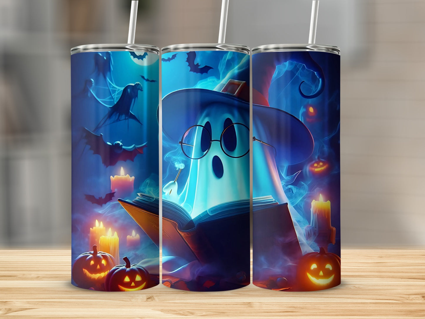 Three tumblers with a Halloween theme featuring a ghost reading a book.