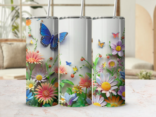 Three tumblers with blue butterflies and colorful flowers.