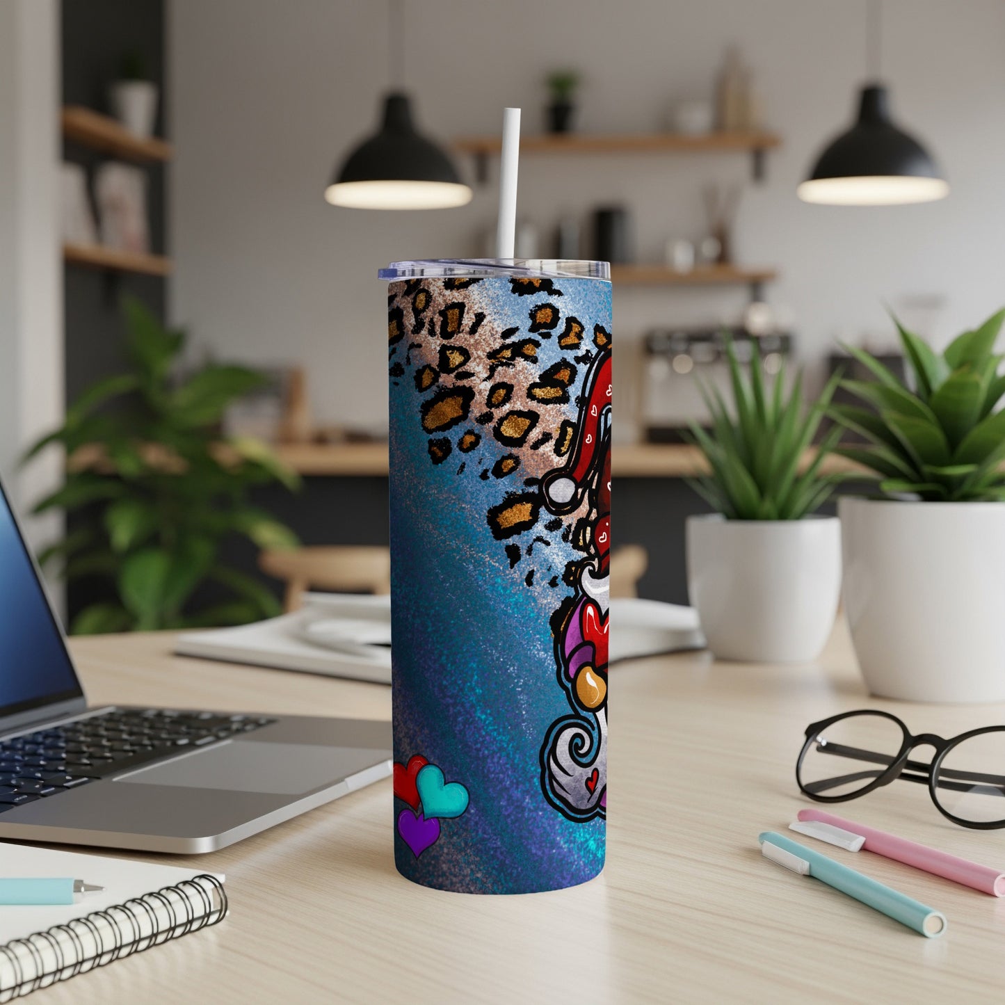 Tumbler with leopard print, hearts, and skull with Santa hat.