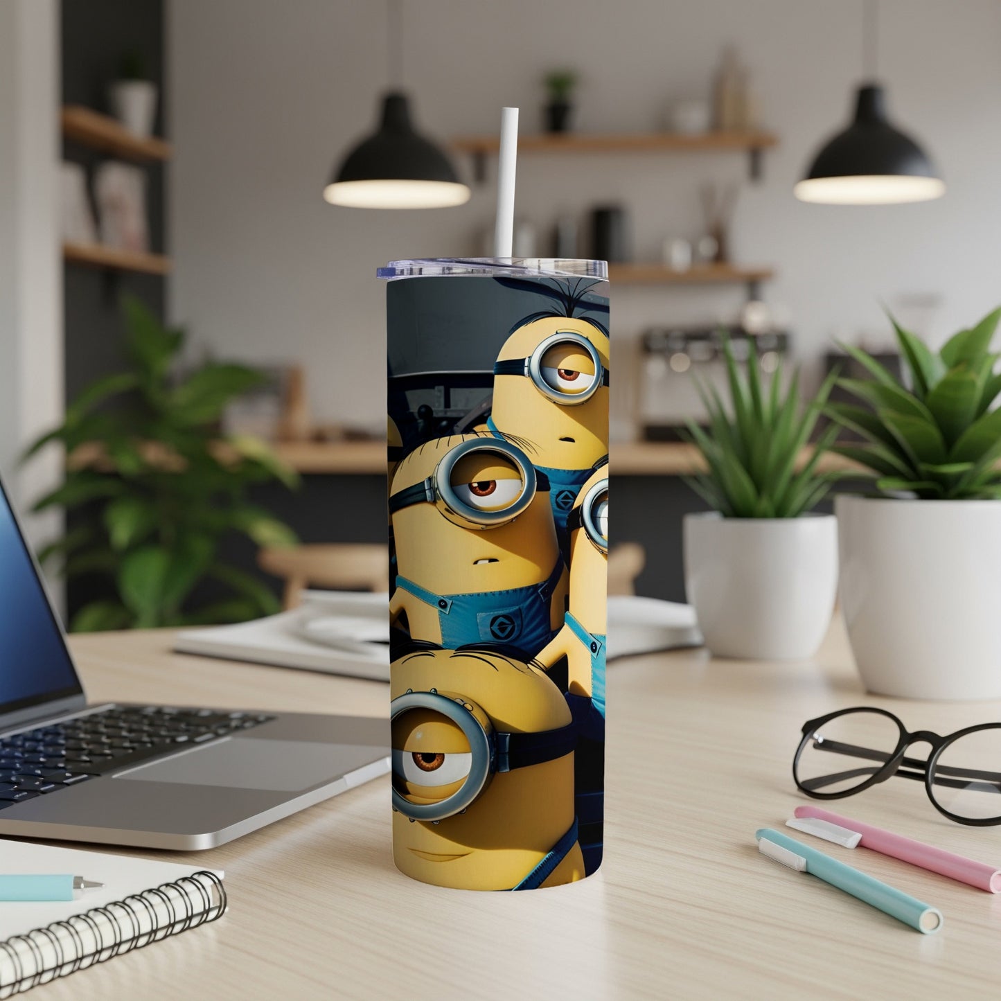 Four Minions with goggles and blue overalls on a tumbler.
