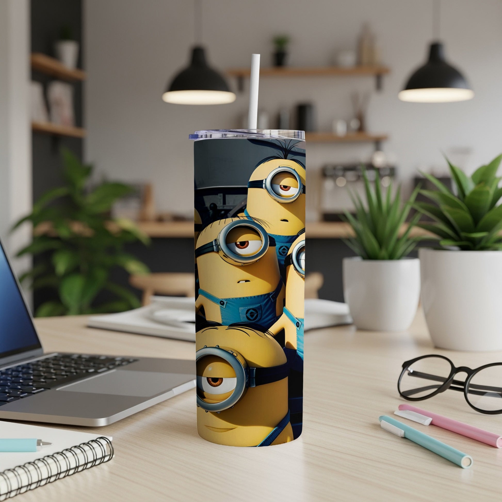 Four Minions with goggles and blue overalls on a tumbler.