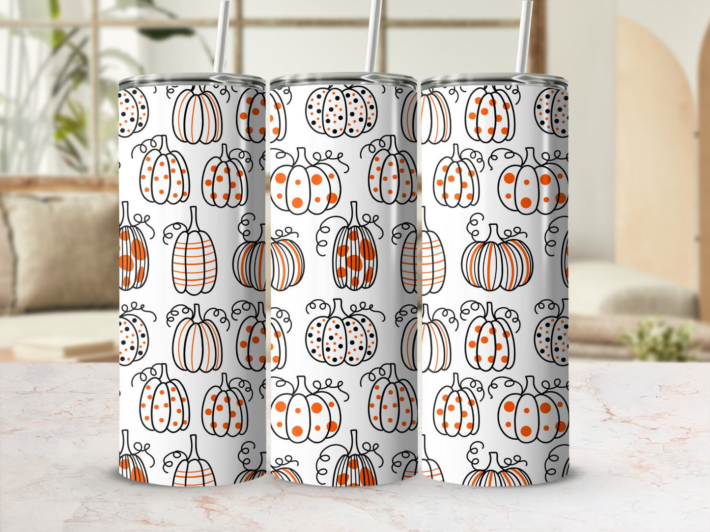 Three white tumblers with orange and black pumpkin pattern.