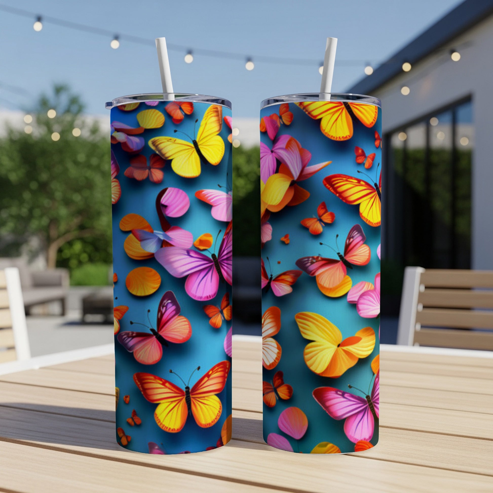 Two tumblers with a vibrant butterfly pattern on a blue background.
