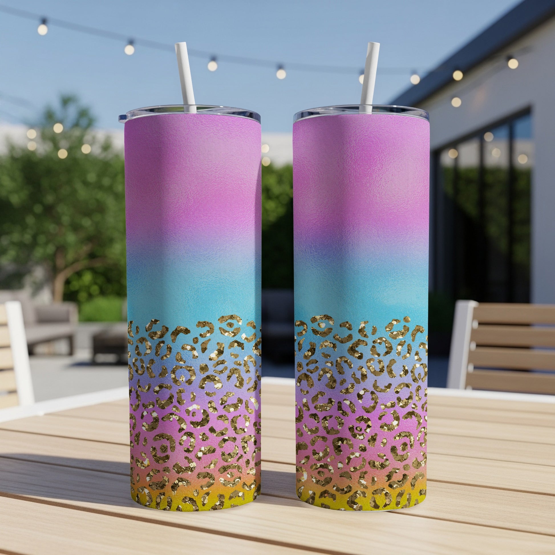 Two tall tumblers with ombre pink, blue, and yellow gradient and gold leopard print.