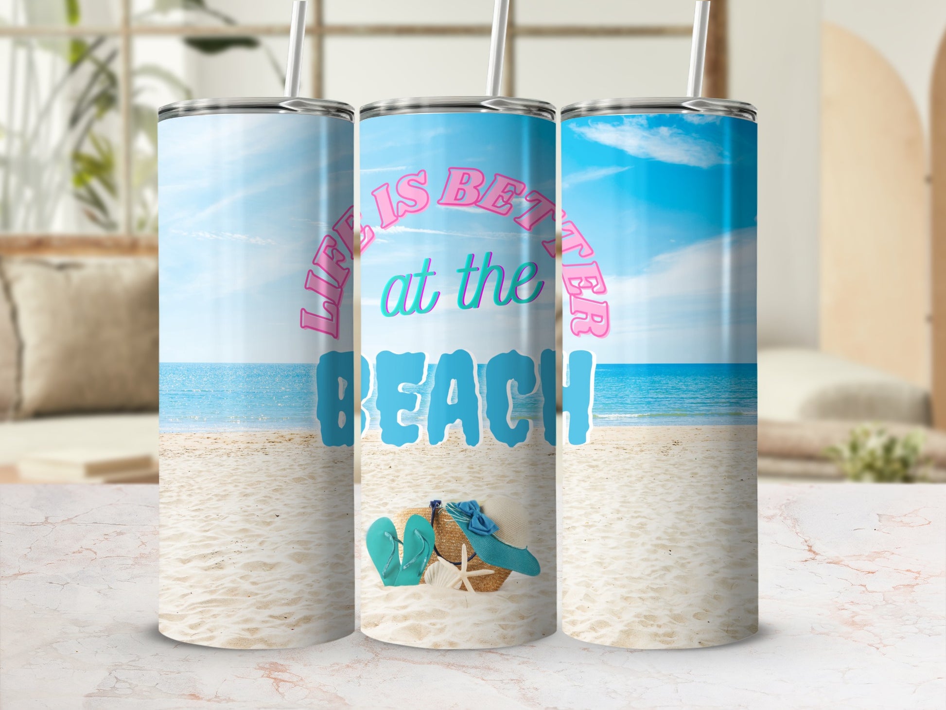Beach scene with three tumblers, one featuring "Life is Better at the Beach" text.