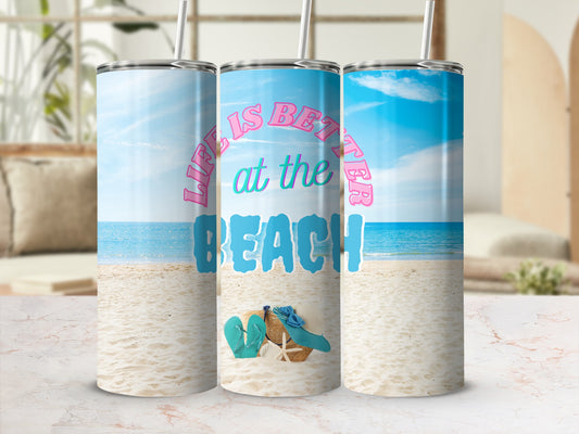 Beach scene with three tumblers, one featuring "Life is Better at the Beach" text.