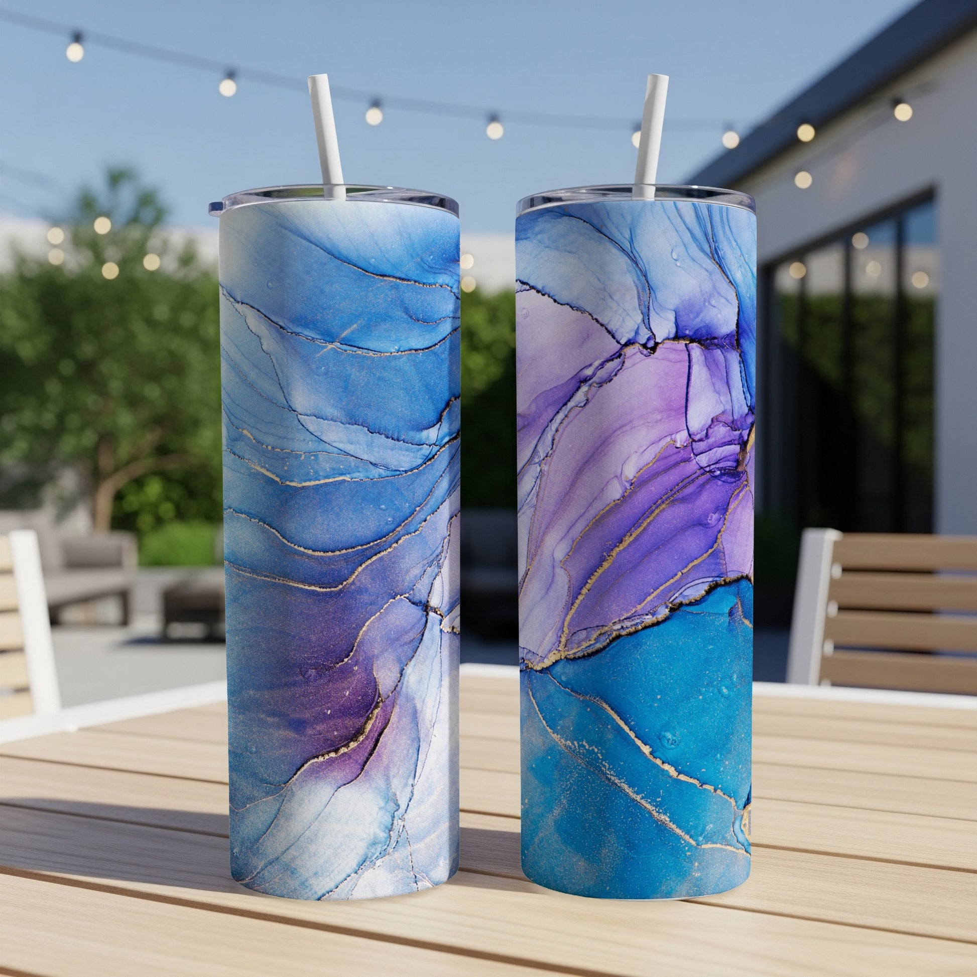 Two tall tumblers with blue and purple marble patterns and gold accents.