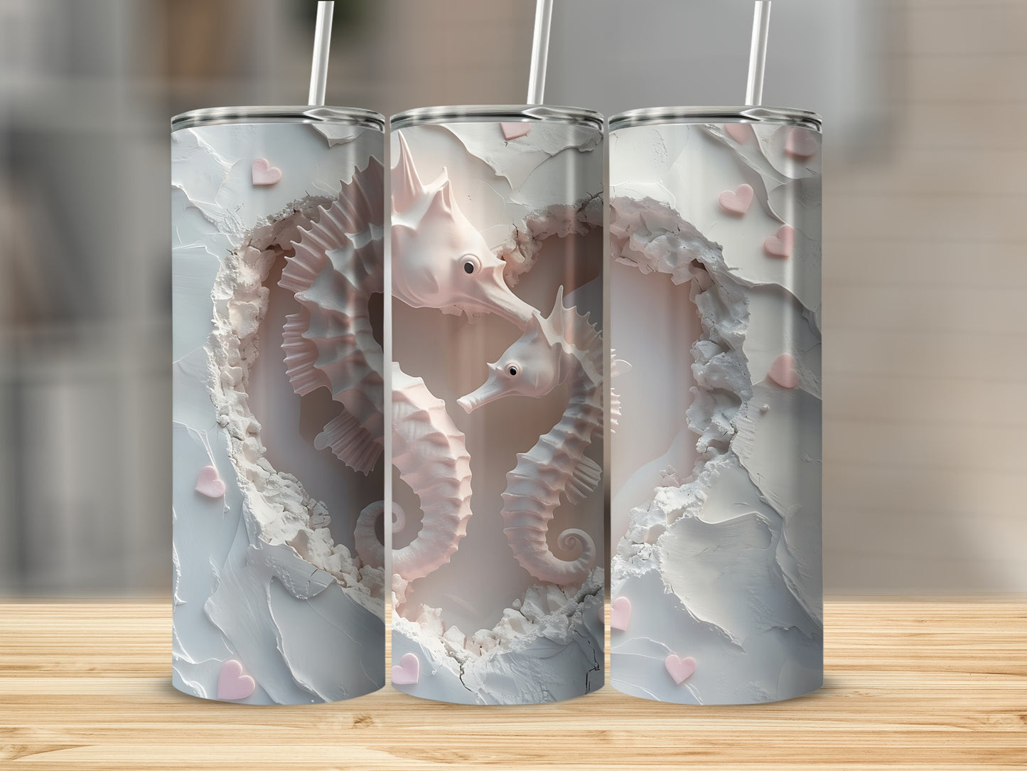Three tumblers with white heart-shaped carving and pink seahorses.