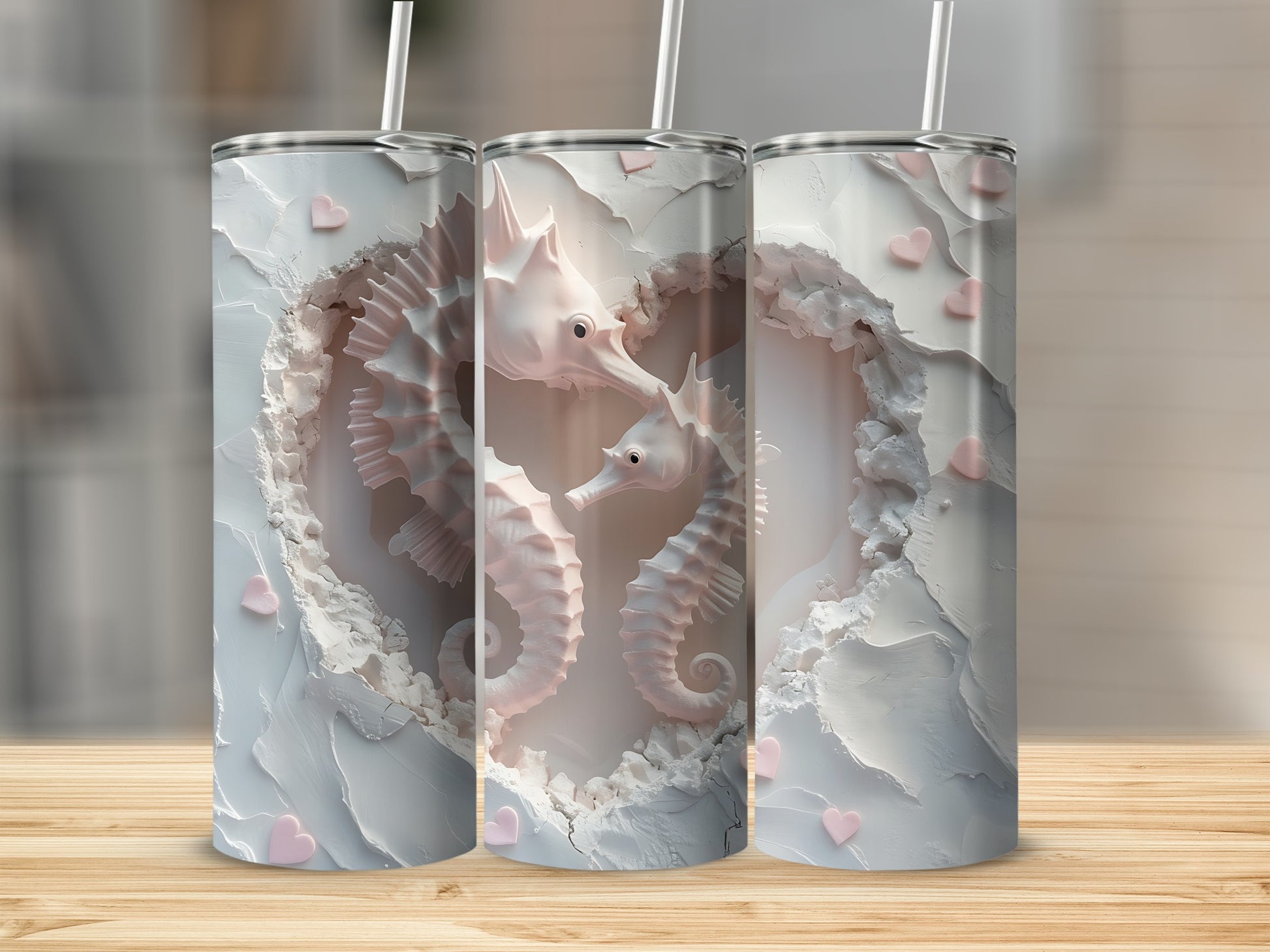 Three tumblers with white heart-shaped carving and pink seahorses.
