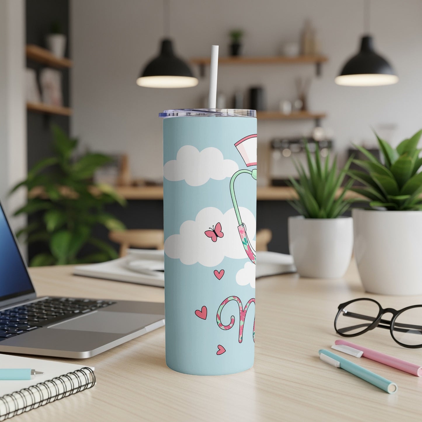 Light blue tumbler with stethoscope, clouds, hearts, and a butterfly.