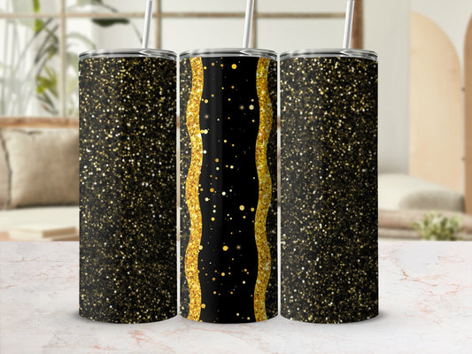 Three glittery black and gold tumblers with straws on a marble surface.