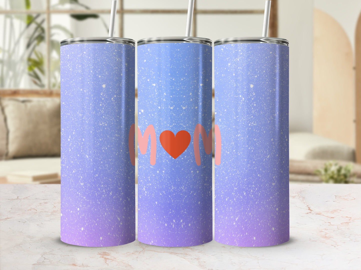 Gradient tumbler with "Mom" in a heart on a blurred background.
