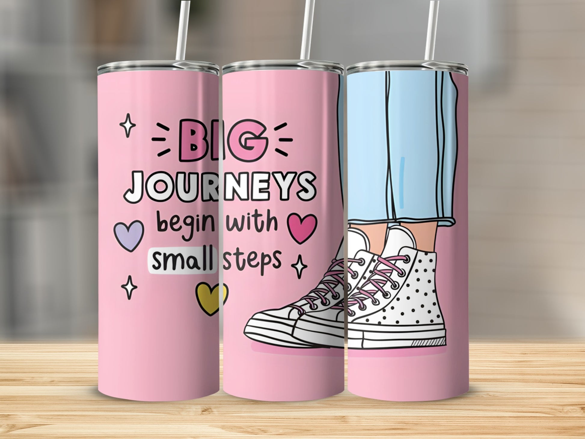 Pink tumbler with "Big Journeys Begin With Small Steps" text and sneakers.