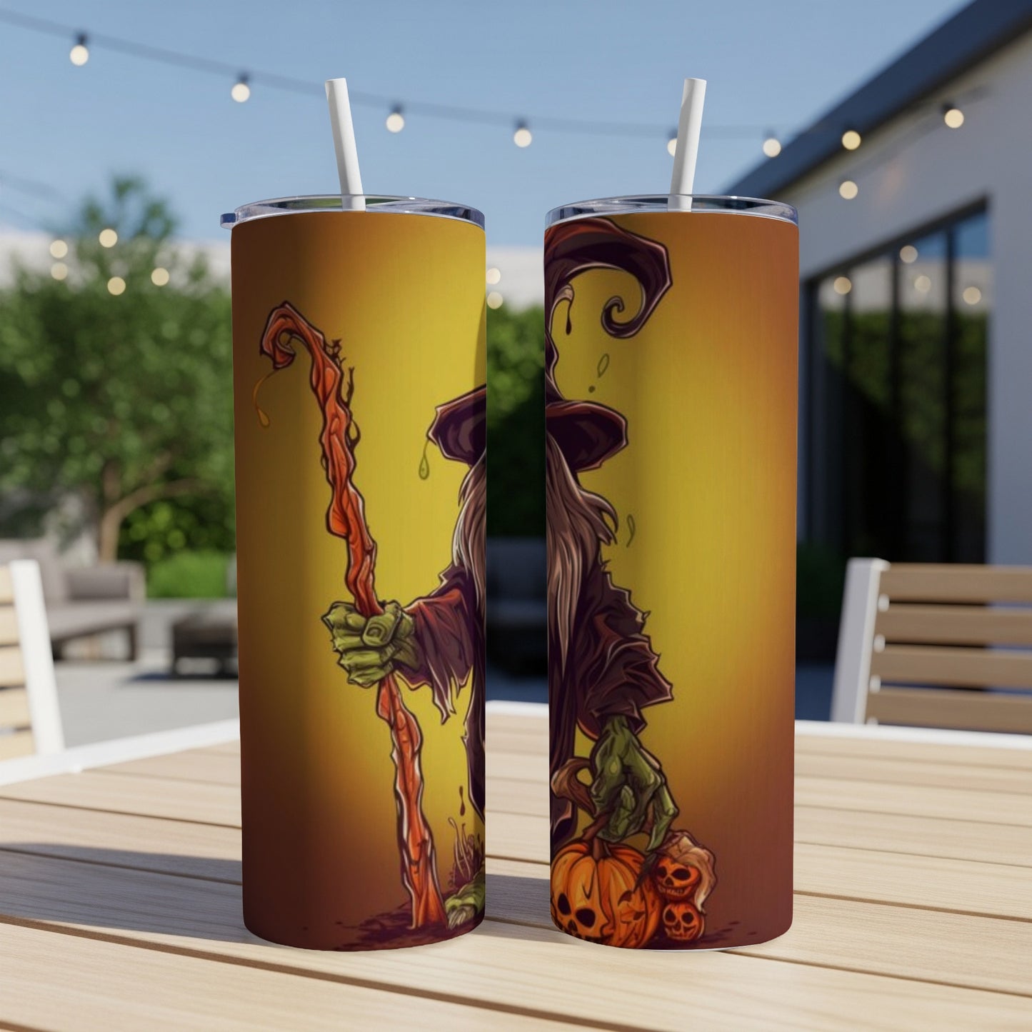 Two tumblers with a Halloween witch design, holding a staff and pumpkins.