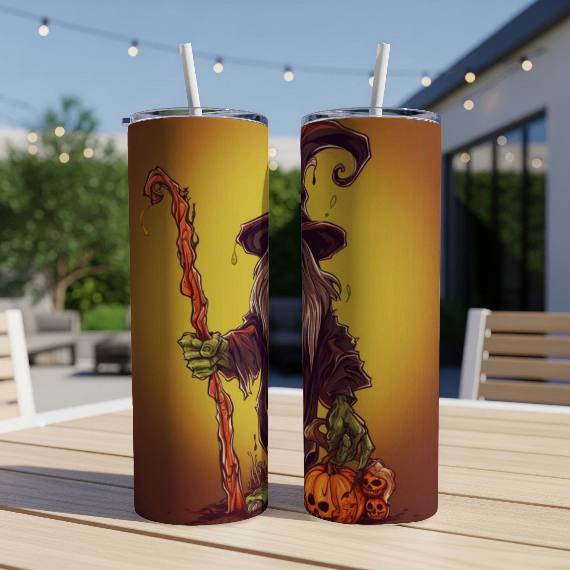 Two tumblers with a Halloween witch design, holding a staff and pumpkins.