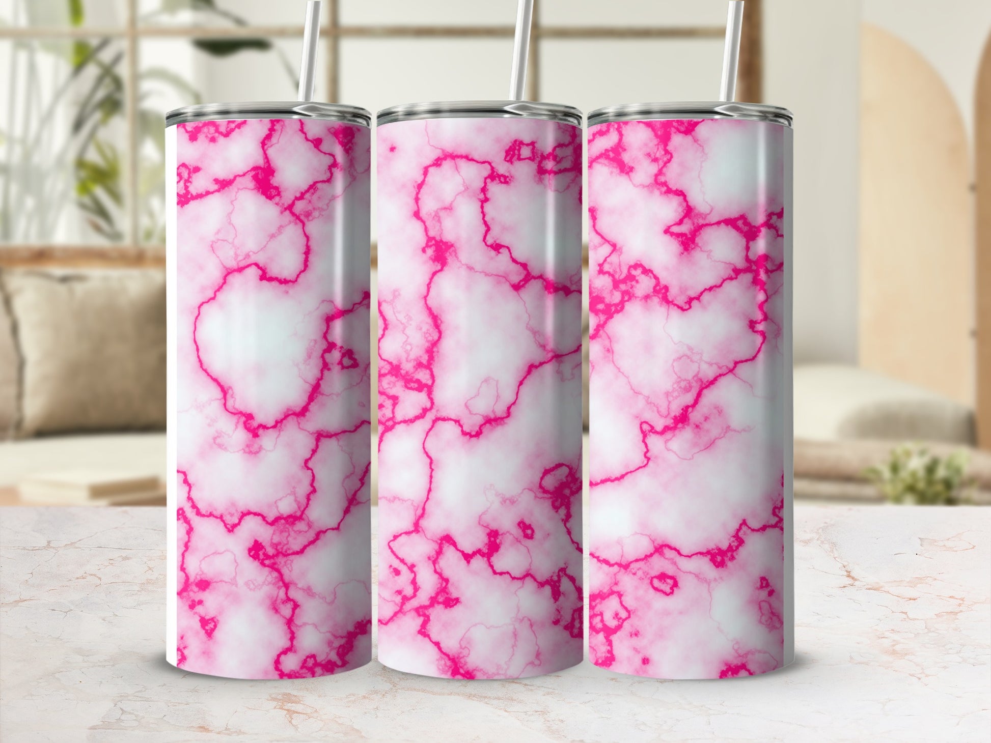Three pink and white marble pattern tumblers with straws.