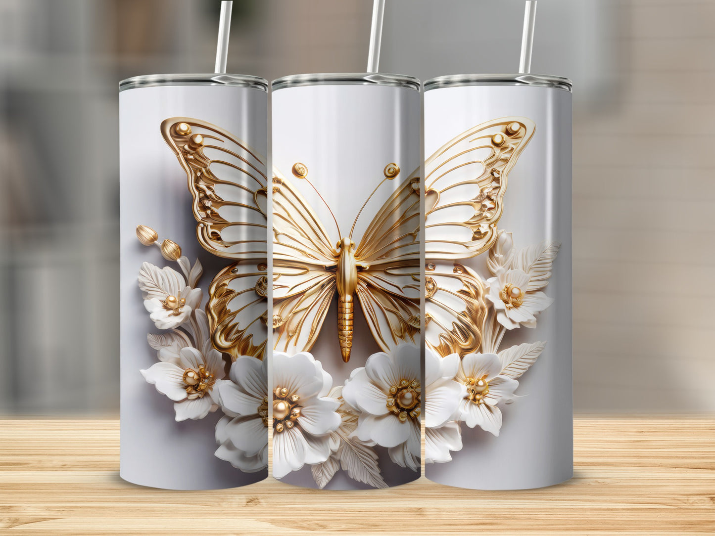 Three white tumblers with gold butterfly and floral designs.