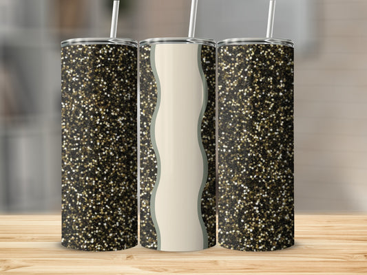 Three glitter tumblers with straws on a wooden surface.