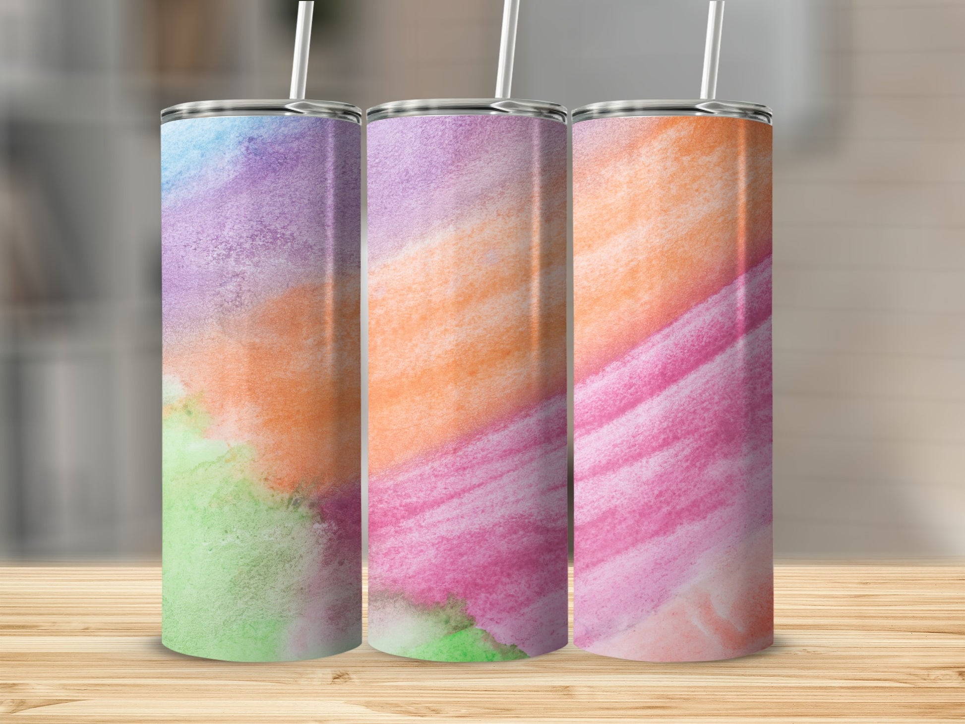 Three tumblers with watercolor-style abstract patterns in purple, green, orange, and pink.