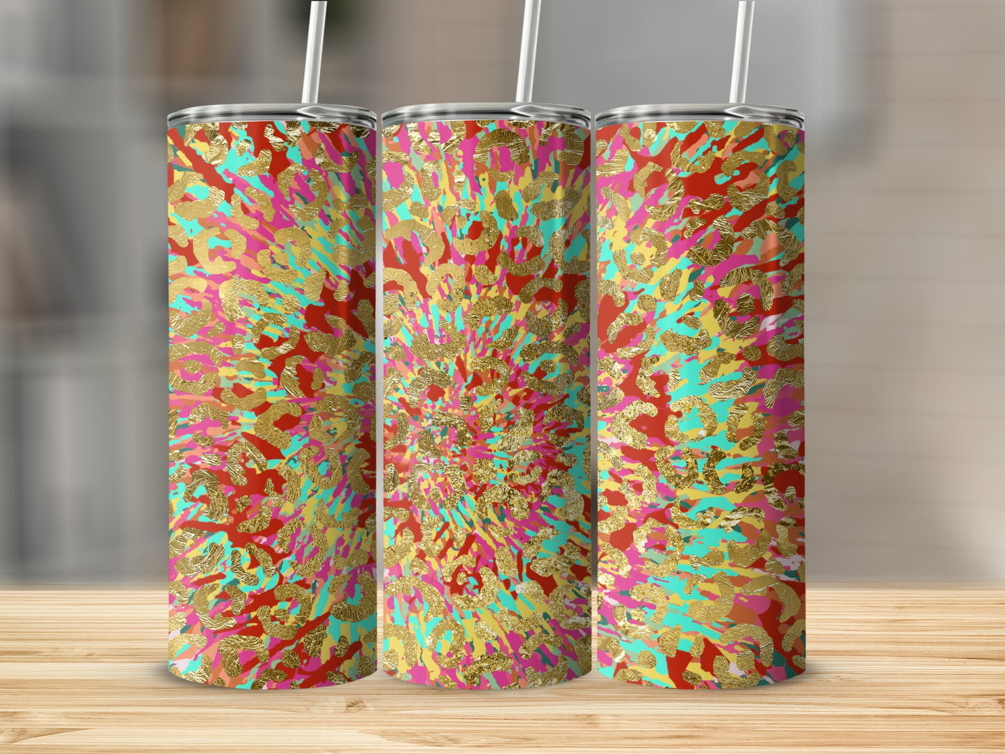 Three tumblers with a vibrant abstract splatter pattern of gold, red, pink, and teal.