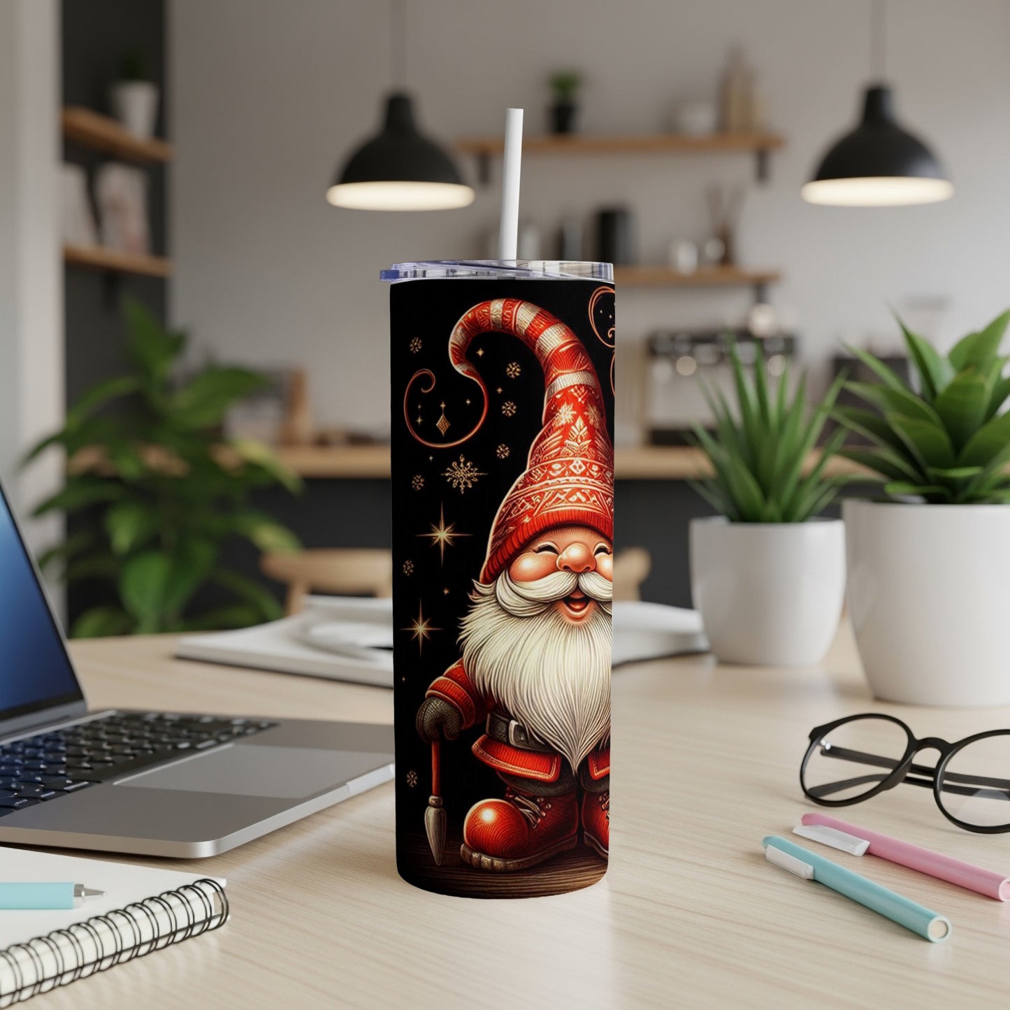 Santa gnome with a paintbrush on a black, starry tumbler with a white straw.