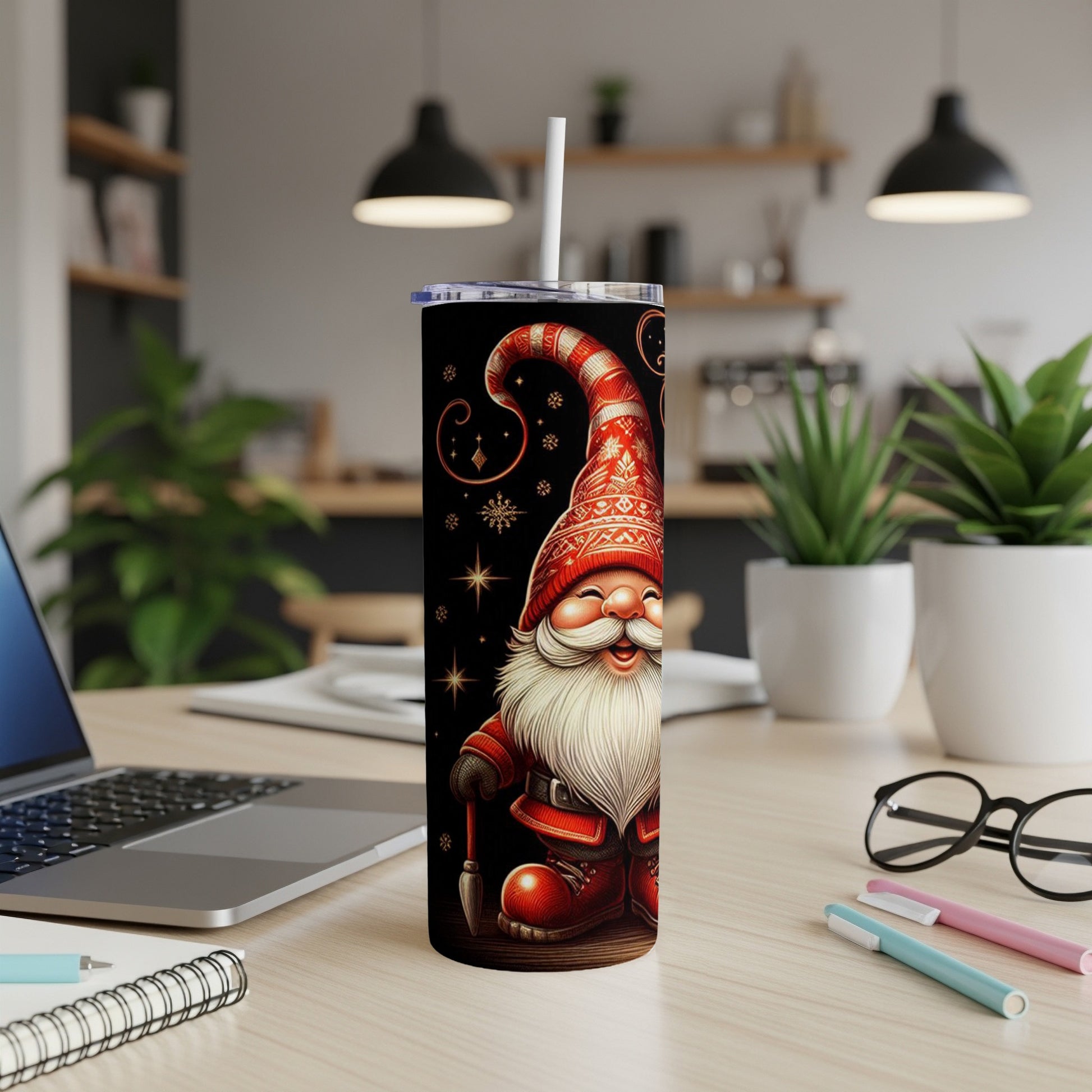 Santa gnome with a paintbrush on a black, starry tumbler with a white straw.
