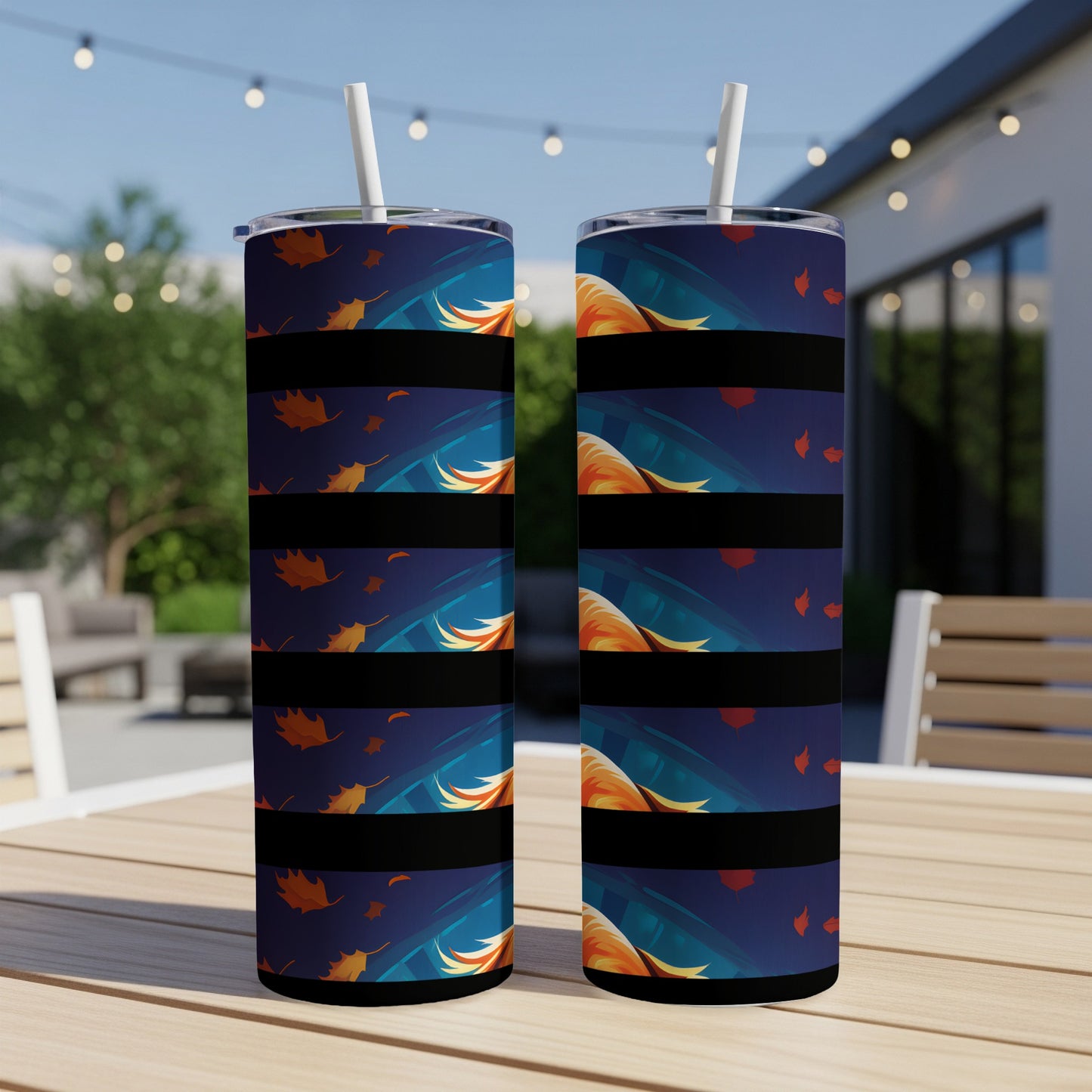 Two tumblers with dark blue wraps featuring falling autumn leaves and abstract fox fur designs.