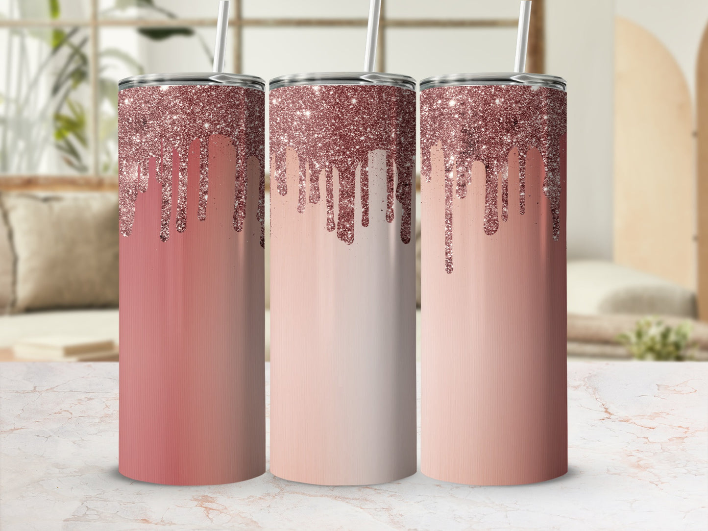 Three rose gold glitter drip tumblers with straws on marble counter