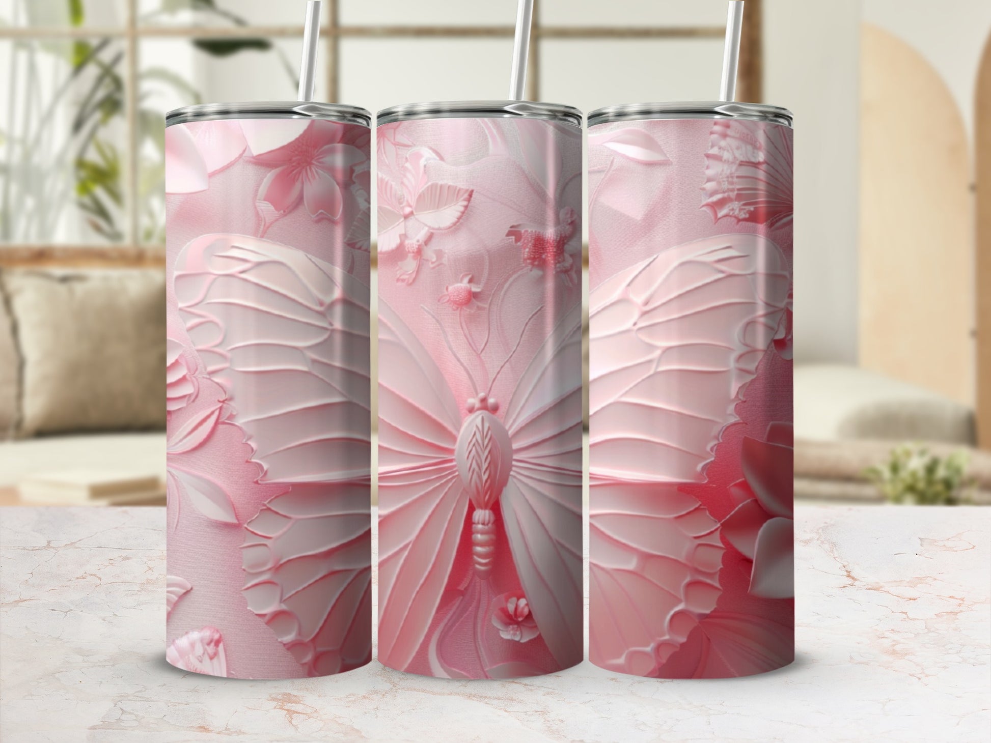 Three pink butterfly tumblers with straw, displayed on a marble countertop.