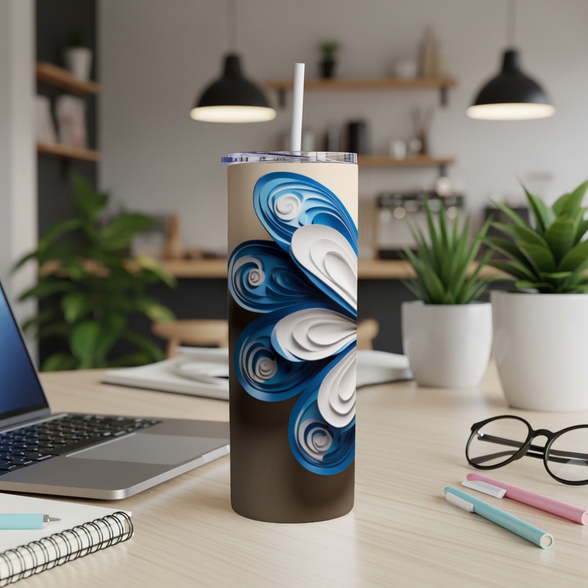 Brown tumbler with blue and white floral design and white straw.