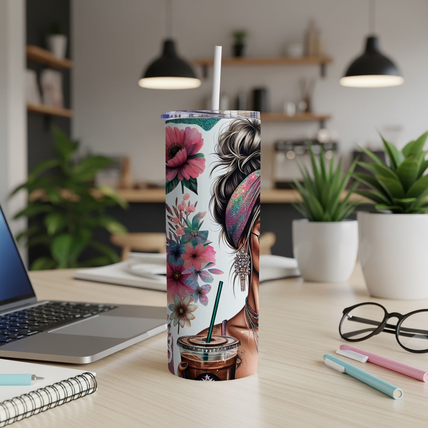 Tumbler with floral design, coffee cup, and woman's face.