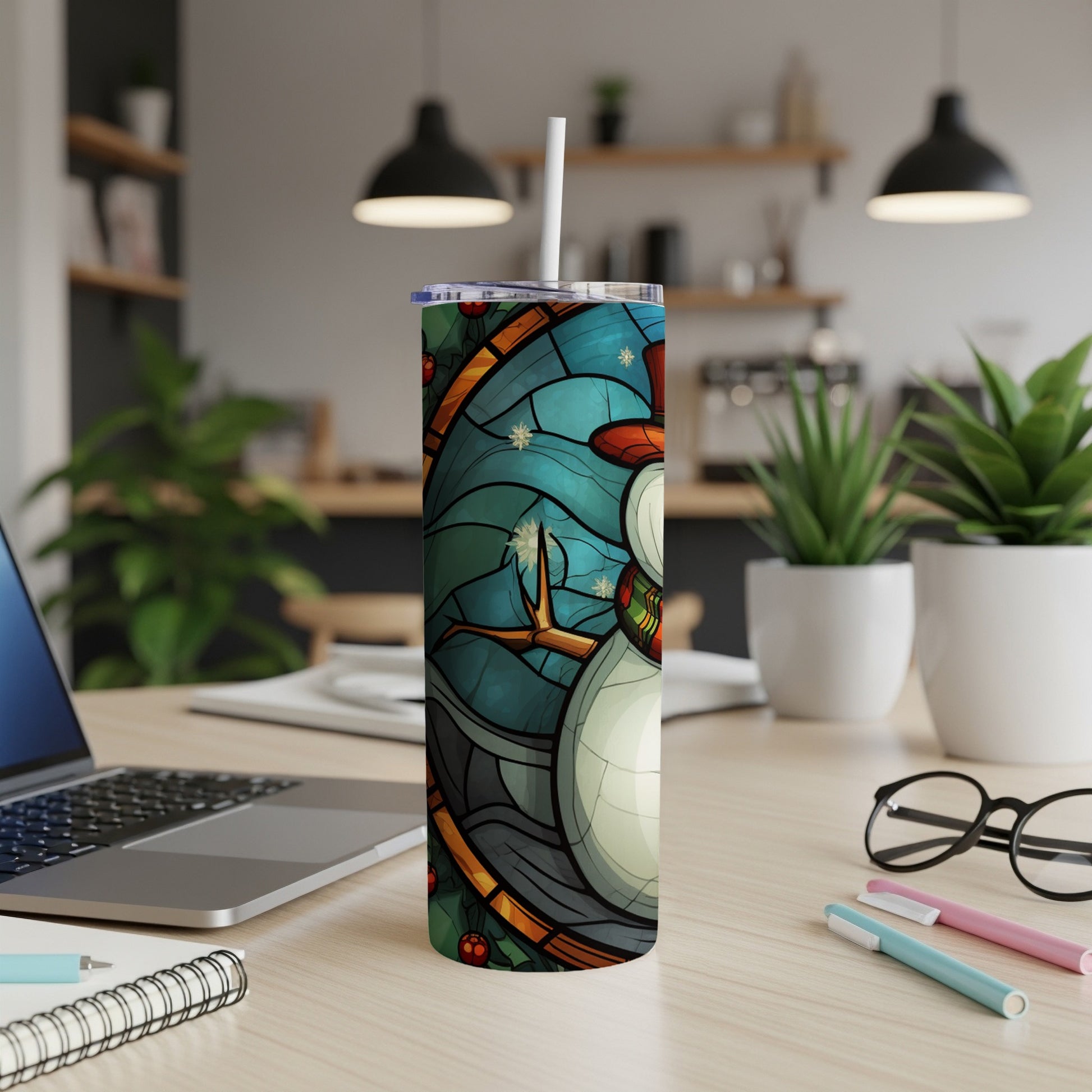 Stained glass snowman design on a white tumbler with a straw.
